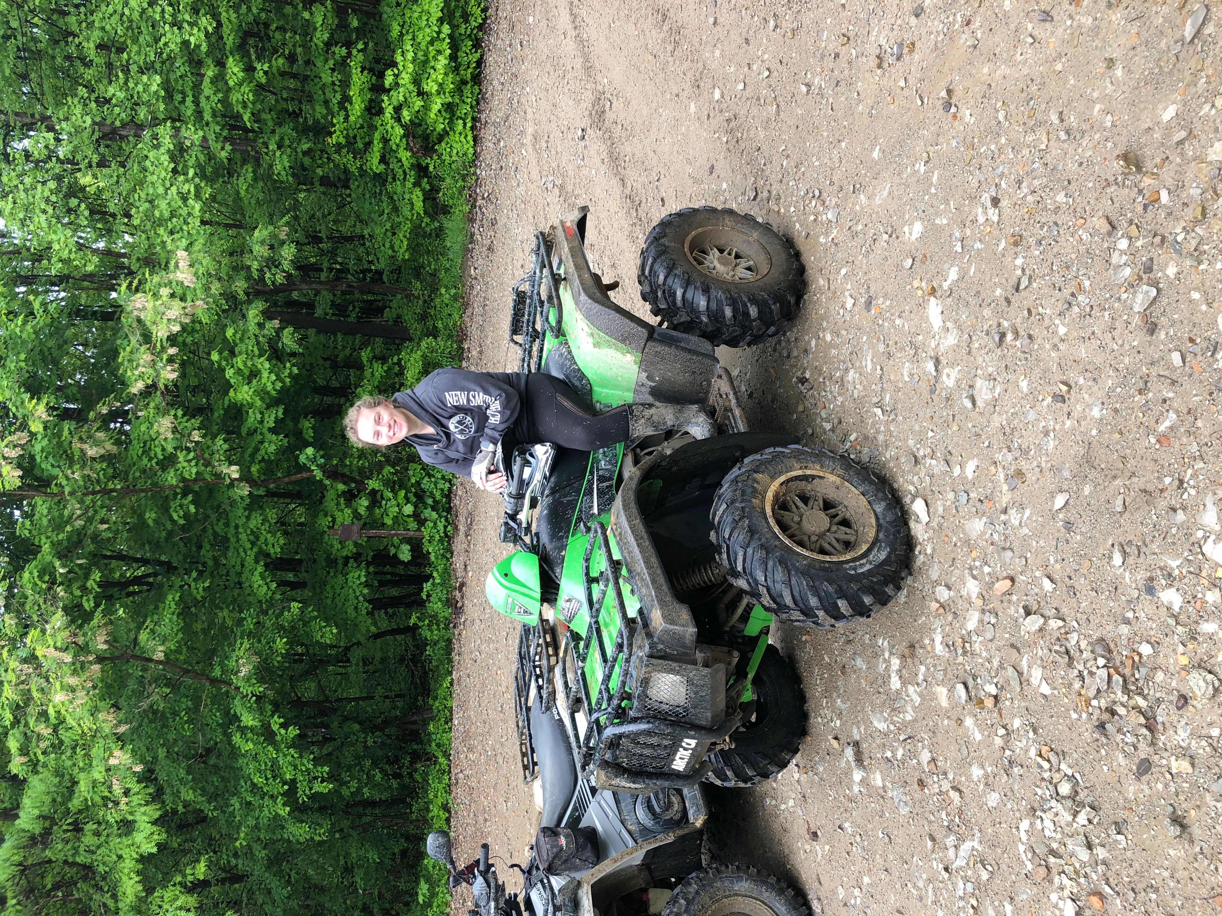 Morgan sitting on green atv